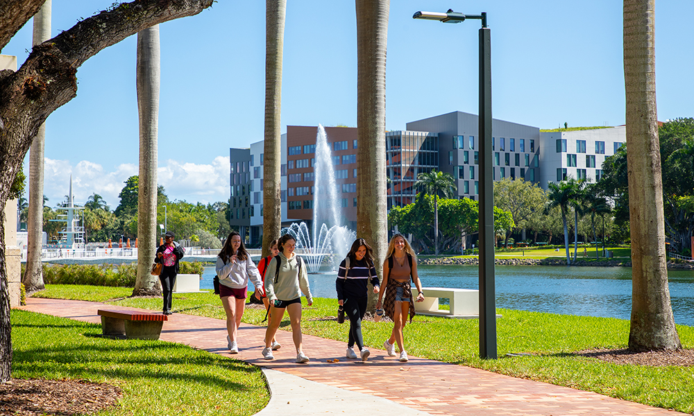 Students walking on campus by the lake